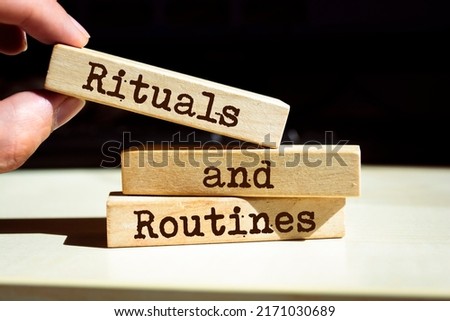 Businessman puts wooden blocks with the words rituals and routines. Foto d'archivio © 