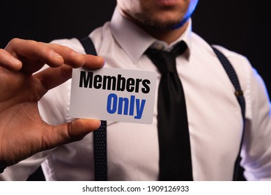 Businessman Putting A Card With Text MEMBERS ONLY In The Pocket.