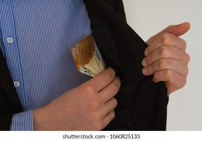 Businessman is putting money into his suit pocket. Euro money, eoro banknotes. closeup