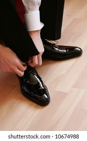 Businessman Putting On Shoes