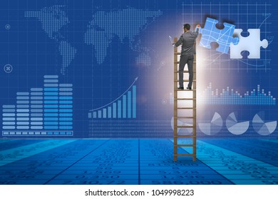 Businessman putting together jigsaw puzzle pieces - Shutterstock ID 1049998223