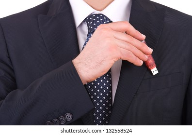 Businessman putting usb stick in his pocket.