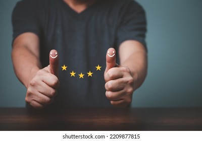 Businessman raised thumbs up and give satisfaction five stars rating, sign of the top service, customer good service.  - Shutterstock ID 2209877815