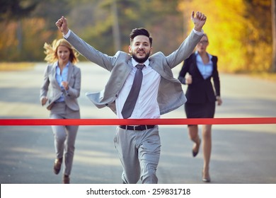 Businessman reaching finish line