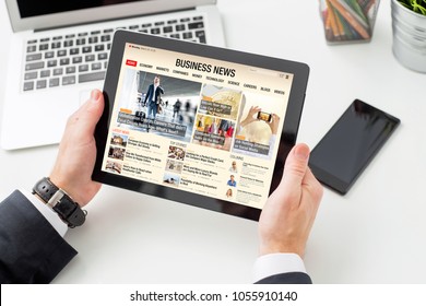 Businessman reading business news on tablet. All contents are made up. - Powered by Shutterstock