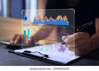 Businessman reading data in bar graph and pie chart form on virtual data analytic dashboard in office. Business analysis for investment and online digital marketing - Powered by Shutterstock - Get 15% off with code: PIKWIZARD15