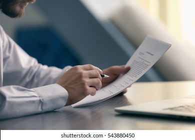 Businessman reading documents - Shutterstock ID 543880450