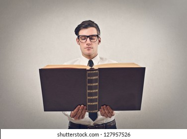 Businessman Reading A Huge Book