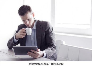 Businessman reading on a tablet pc at the office