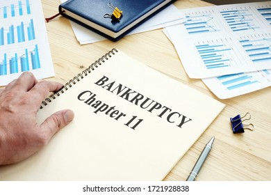 Businessman reads Bankruptcy Chapter 11 book. - Shutterstock ID 1721928838