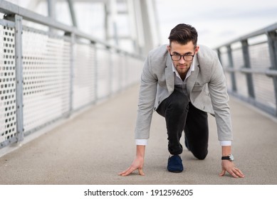 Businessman ready to run on the bridge. Focused yuppie ready to start with copy space