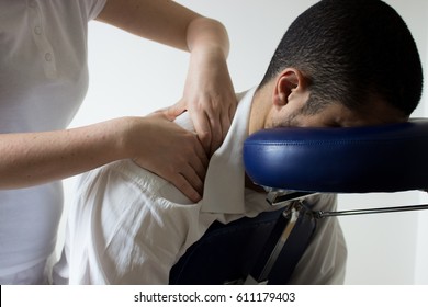 businessman receiving shiatsu on a quick massage chair