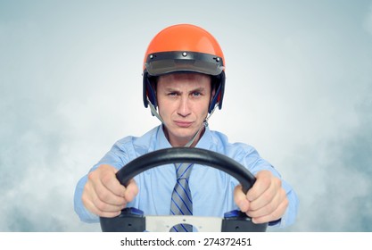 Businessman In A Red Helmet With Steering Wheel, Car Drive Concept