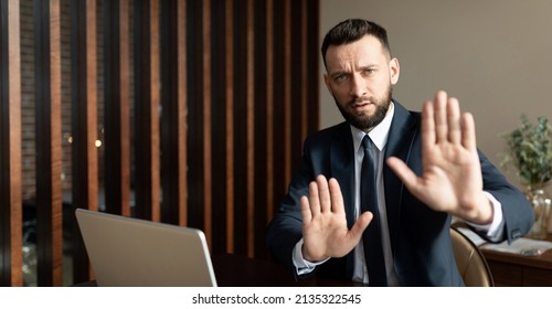 businessman refuses to work with partner due to cancellation policy, man in business suit in modern office gesturing no