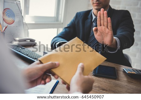 Businessman refusing money in the envelope offered by a man - anti bribery and corruption concepts