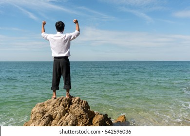 Businessman relax office Dress standing happy action on the beach, Copy pace on Right side,  Holiday vacation time concept.