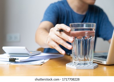 Businessman In Relaxing Casual Working From Home. Modern Working Lifestyle Concept With Copy Space. Man Drinking A Mineral Water In Glass During Working, Refreshment During Hard Working.