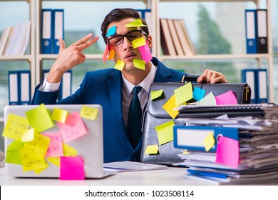 Businessman with reminder notes in multitasking concept - Shutterstock ID 1023508114