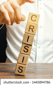 Businessman removes wooden blocks with the word Crisis. The exit from the crisis and financial stability. Focus on resolving the midlife crisis. The rise of the economy and business development.