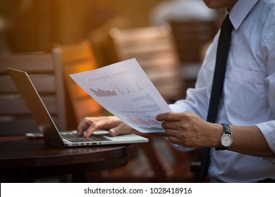 Businessman Research study and   Auditing Income Statement Data from Excel Spreadsheet. Audit Making  Database Report Financial Planning Report in Cafe in the park near the Office before entering meet - Shutterstock ID 1028418916