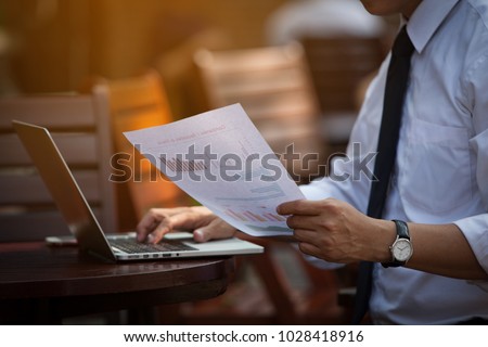 Businessman Research study and   Auditing Income Statement Data from Excel Spreadsheet. Audit Making Database Report Financial Planning Report in Cafe in the park near the Office before entering meet