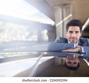 Businessman Resting On Car In Parking Garage