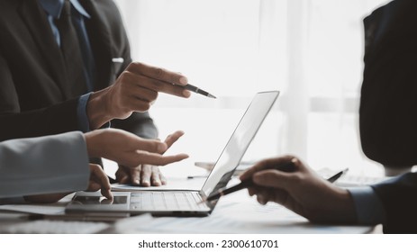 Businessman is reviewing monthly sales documents for analysis and marketing plans for more sales growth, they are the founders of young companies co-founding startups. Sales management concept. - Powered by Shutterstock