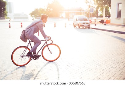 Businessman Riding Bicycle To Work In Town 