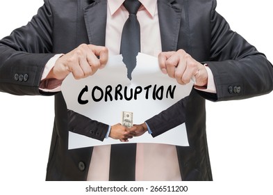 Businessman ripping up the CORRUPTION sign with Hand shake between a businessman and dollar money on white background - Shutterstock ID 266511200
