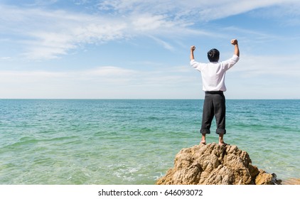 businessman rising hands on blue sea background, copy space on Left side.