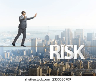 Businessman in risk concept walking on tight rope