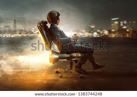 Businessman rolls on office chair with rocket motor
