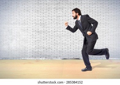 Businessman running fast over textured background - Shutterstock ID 285384152