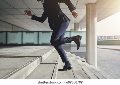 Businessman running up the stairs  - Powered by Shutterstock