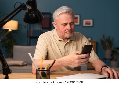 A Businessman Runs Errands On The Phone, Works On The Phone, Makes A Wire Transfer. A Senior Citizen Dials A Phone Number On His Cell Phone. Older Man Orders Clothes Online, Does Grocery Shopping