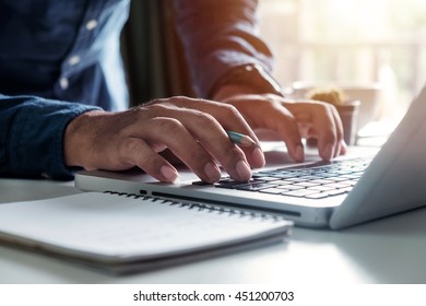 Businessman s hands typing on laptop keyboard in morning light (computer, typing, online) - Shutterstock ID 451200703