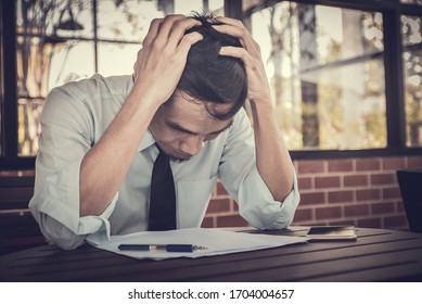 Businessman sad sitting in cafe unhappy business fail Corona virus lock down effect to business - Shutterstock ID 1704004657