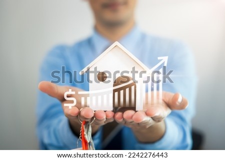 Businessman, salesman to hold model of home, house. Include increase graph or chart of price forecast. To offer for sale, investment. Concept for value, income, wealth, asset, real estate and property