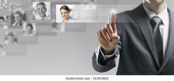 Businessman searching a user profile online and touching a touch screen interface - Shutterstock ID 313415810