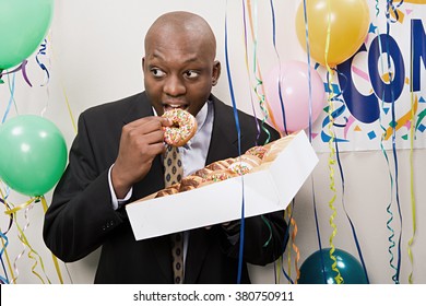 Businessman Secretly Eating Doughnuts