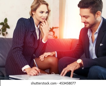 Businessman Seduce Businesswoman On Sofa, Put Hand On Leg, Sexual Harassment, Reviewing Documents