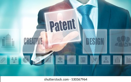 A businessman selecting a Patent Concept button on a clear screen.