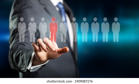 businessman selecting a person out of a group on a virtual screen in front of an abstract blue background - Shutterstock ID 1909087276