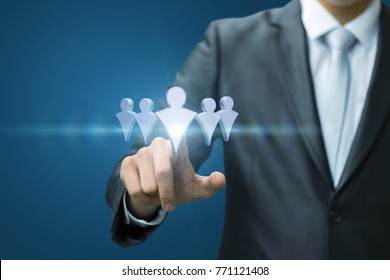 Businessman selects an employee in the group on a blue background.