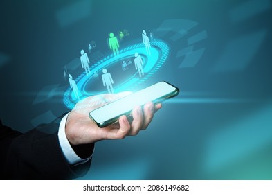 Businessman selects a new employee among candidates on phone. Futuristic hologram, innovative. Staffing, human resources management. Employment. IoT technologies. Business communication. Team feedback - Shutterstock ID 2086149682