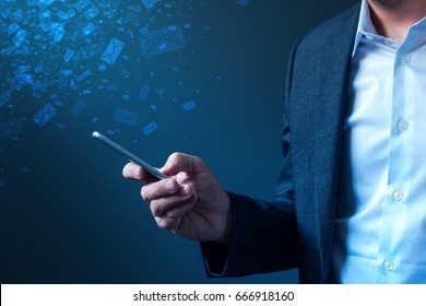 Businessman sending bulk messages using smartphone, male business person in elegant suit delivering e-mails, newsletters or SMS text messages with his mobile phone app