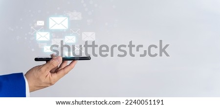 Businessman sending email Bulk mail touching smartphone with digital hologram email and message banner on white isolated background. business email ideas