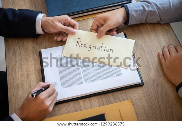 Businessman sending a resignation letter to employer boss in order to dismiss contract, changing and resigning from work concept.