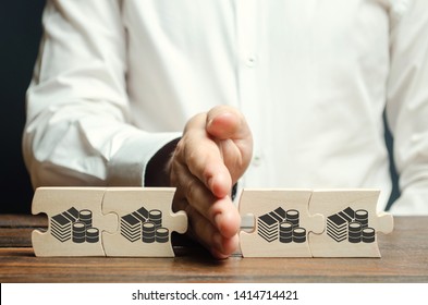 Businessman separates the wooden puzzle with a picture of money. The concept of financial management and distribution of funds. Saving and investing. Property division. Divorce and legal services - Shutterstock ID 1414714421