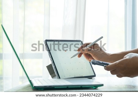 Businessman sets calendar for business meetings and company meetings. taking notes on tablet business meeting concept and develop the organization